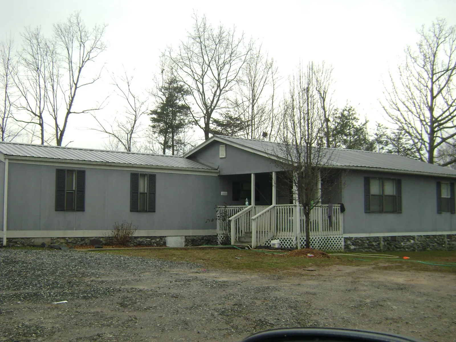 Metal roof over a manufactured home with a covered front porch in Southampton